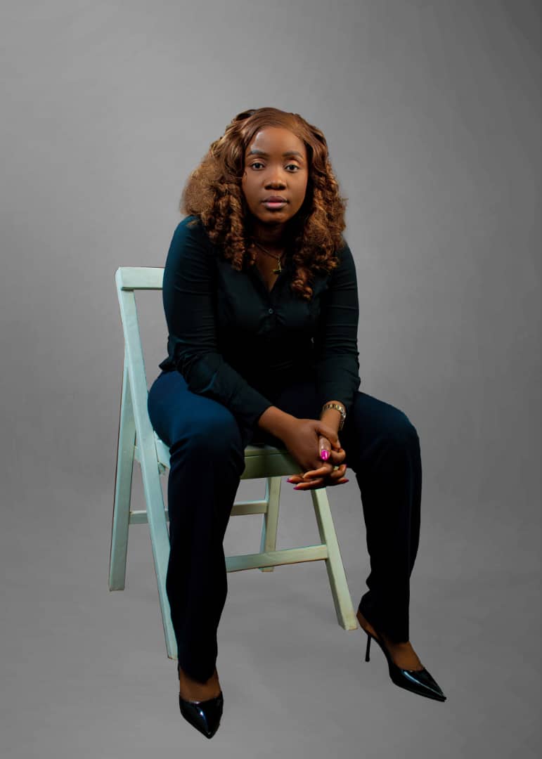 Dr. Tosin Faremi seated